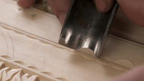 Carving wood using cutter tool. Detail of carving wood with a chisel, super macro shot. Close up process of man making wooden box. Carving wood stick on the table using cutter tool. Carpenter at work. - Powered by Shutterstock - Get 15% off with code: PIKWIZARD15