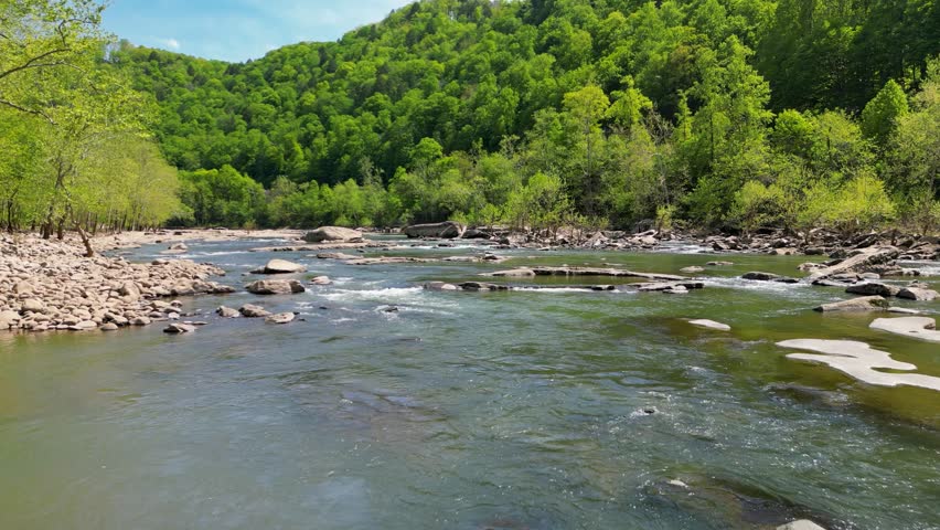 Aerial view along West Virginia River with rapids and large boulders