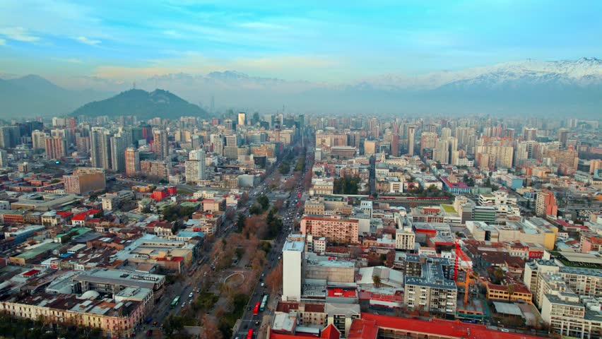Cityscape of Santiago de Chile La Alameda Avenue Drone Aerial Fly Andean Cordillera city colorful buildings, metropolitan residential area