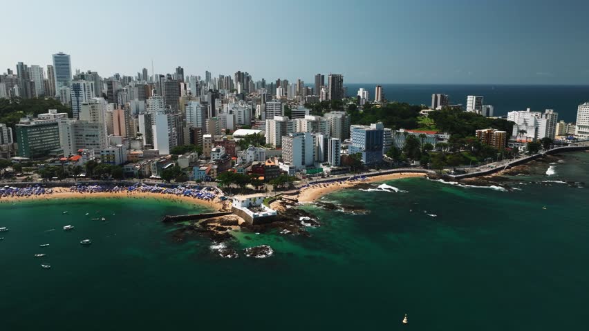 Aerial view of Salvador da Bahia cityscape, beach and azure sea, yachts and boats. Tropical Travel Destination. Aerial landscape of Coastal City. Salvador, Bahia, Brazil.