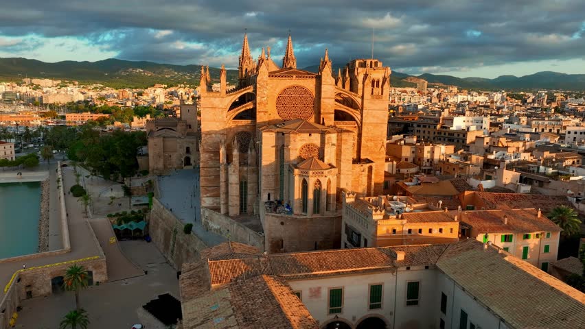 sunrise aerial view of cathedral of Palma de Mallorca, Palma de Mallorca cityscape. Cathedral of Santa Maria, Royal Palace of La Almudaina. Balearic Islands. Spain. High quality 4k footage