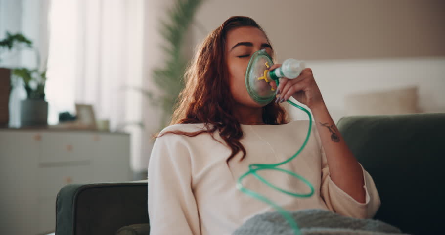 Woman, sick and respiratory illness with oxygen mask, health and wellness for medical condition. Female person, virus and nebulizer or pneumonia, asthma or recovery with eyes closed as cure in home