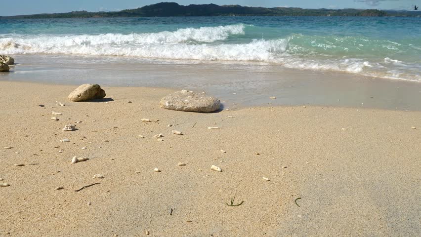 Waves on tropical beach slowmotion, Nosy Be, Nosy Fanihy, Madagaskar, Africa.