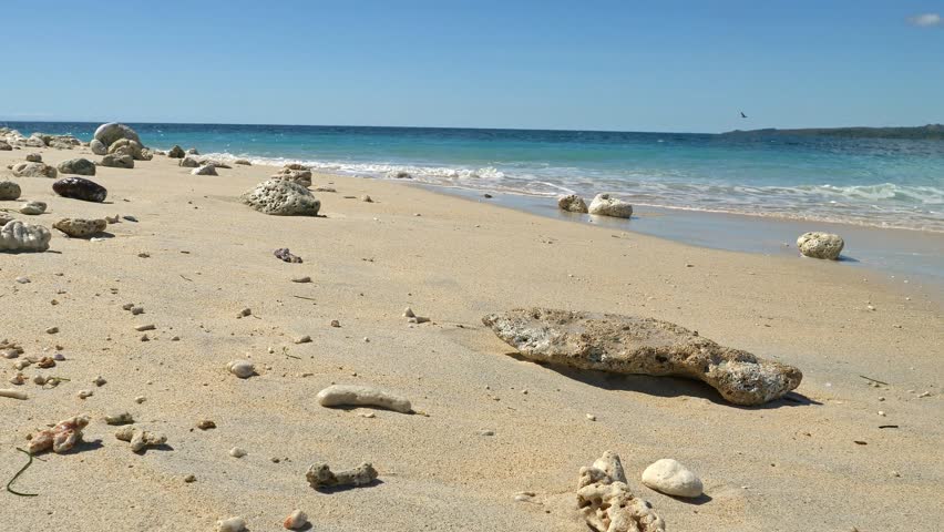 Waves hitting rocks on tropical beach, Nosy Be, Nosy Fanihy, Madagaskar, Africa.