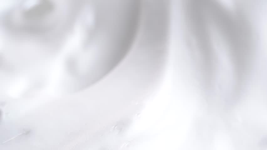 Beauty background with foam mousse, macro. Close up of white cloud of shaving mousse foam.