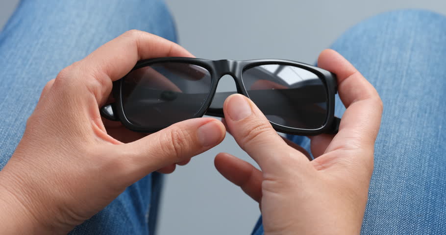 Woman hands with a sunglasses.