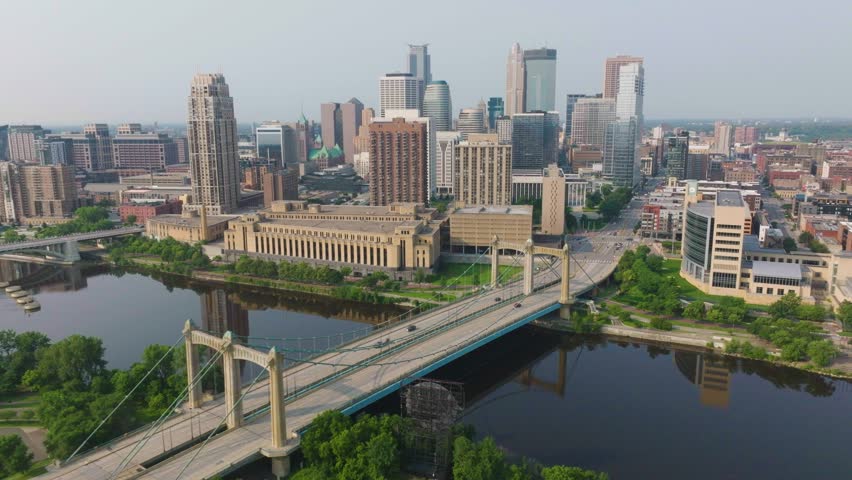 Drone shot of Hennepin Avenue Bridge with Minneapolis skyline in background. Minnesota during daytime in USA.