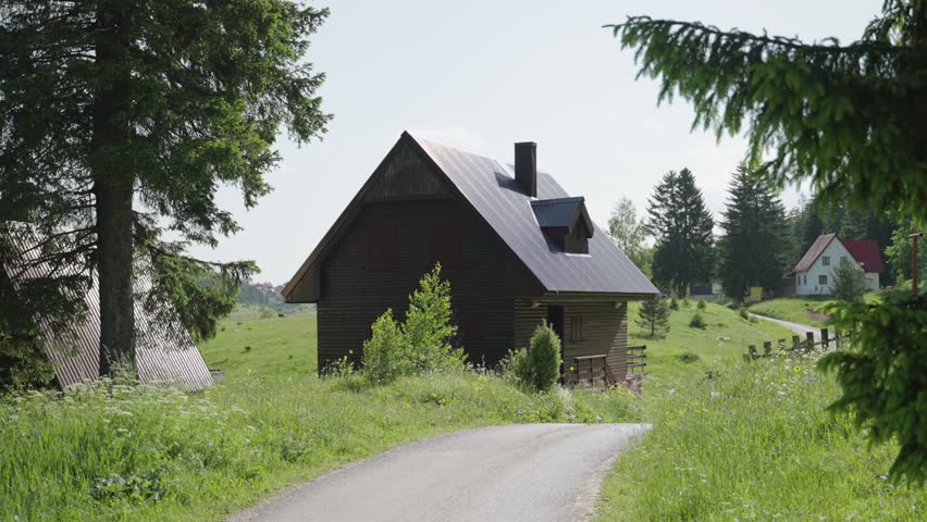 Small wooden cabin or lodge for winter season use in the Balkan Montenegro. Cute small house closed during summer and springtime in picturesque town of Zabljak in the green mountains of Montenegro