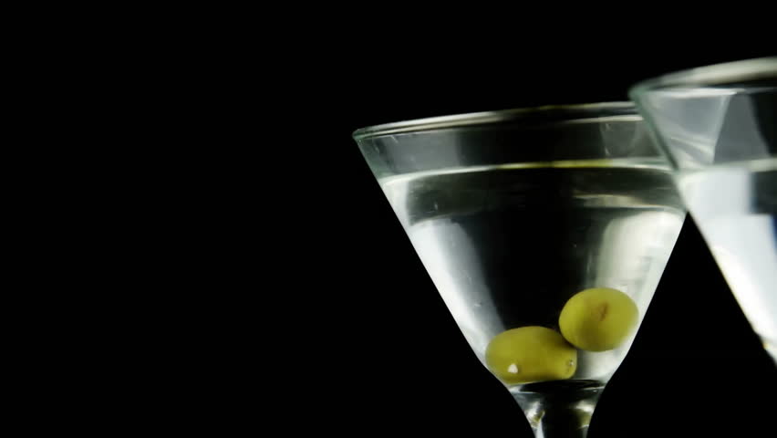 Martini glasses with olives and golden confetti animation. Cocktails, celebration, festive, luxury, party, drinks