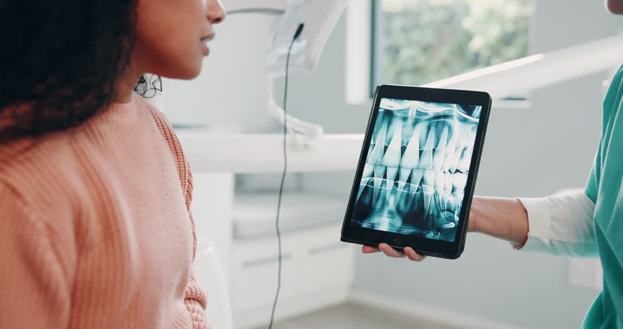 Hospital, woman and dentist with tablet screen for x ray, teeth diagnosis and dental structure in appointment. Results, patient and doctor with tech for orthodontic procedure and planning for surgery