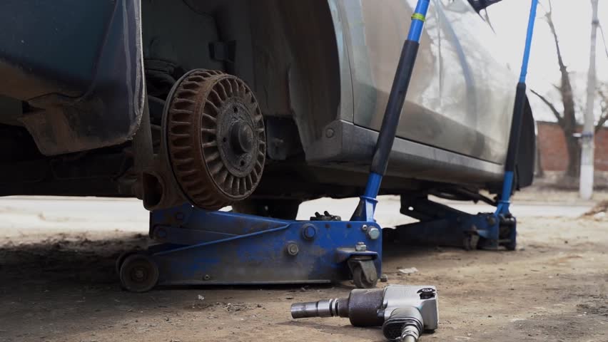 car at a tire shop changing tires to winter ones