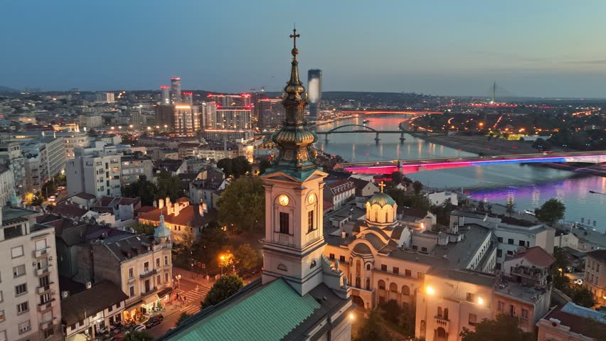 Sunset view of Belgrade with city lights. Flying over Cathedral of Saint Michael, Sava river, bridges and old town in Belgrade - capital of Serbia