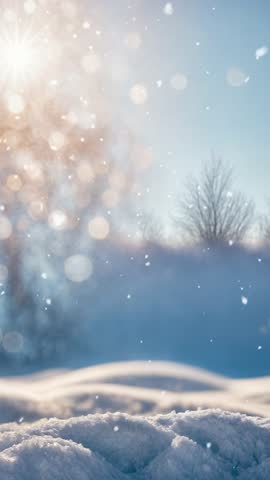 Winter snow background with snowdrifts, with beautiful light and snow flakes on the blue sky, beautiful bokeh circles, banner format, copy space.