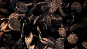 Dark chocolate chips fly and fall. Filmed on a high-speed camera at 1000 fps. High quality FullHD footage - Powered by Shutterstock - Get 15% off with code: PIKWIZARD15