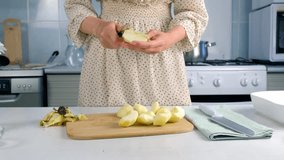 Woman peeling cutting apples cooking dish on kitchen at home, hands close-up. Female housewife in dress preparing dish from apples. Culinary, cuisine, healthy eating, baking concept. - Powered by Shutterstock - Get 15% off with code: PIKWIZARD15