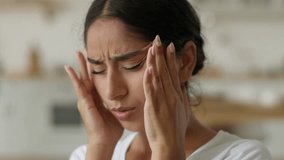 Ill sick tired exhausted fatigued suffering bad feeling Arabian woman Indian girl lady female at home migraine pain headache painful head symptom health problem medicine painkiller stress pressure - Powered by Shutterstock - Get 15% off with code: PIKWIZARD15