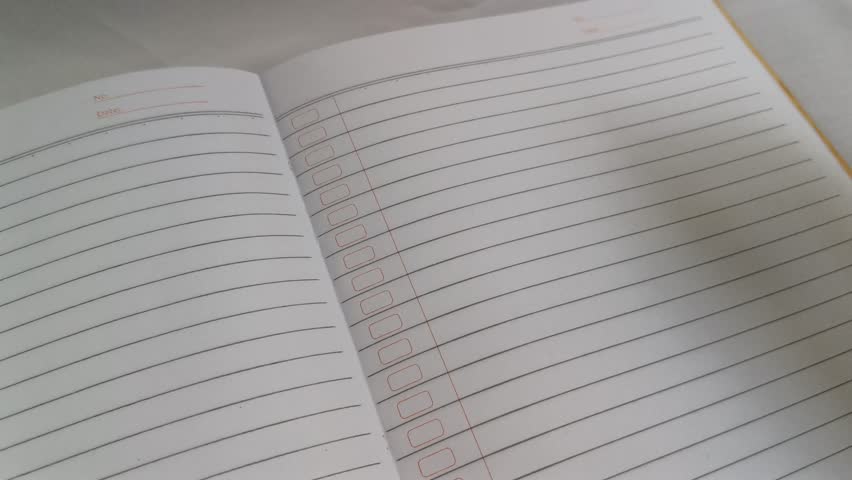 Hand is writing Hello in a notebook with pencil 