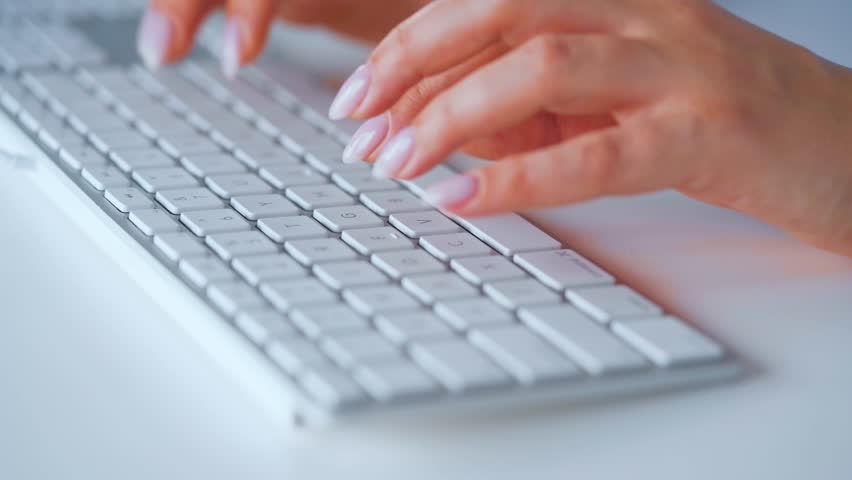 Female hands typing on a computer keyboard, focusing on the benefits of remote work and digital communication tools. Great for webinars on telecommuting, virtual team collaboration