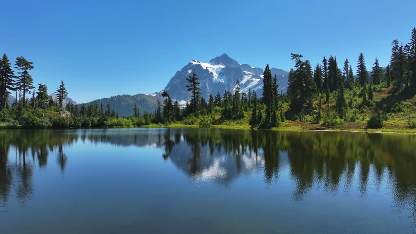 Aerial view of Picture Lake, Mt. Baker Wilderness Area - gliding over the forest