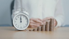 Money Saving for Future Plan, Retirement fund, Pension, Investment, Wealth Business and Financial concepts. hand putting coin into piggy bank with clock, Counting and stack arrangement for deposit - Powered by Shutterstock - Get 15% off with code: PIKWIZARD15
