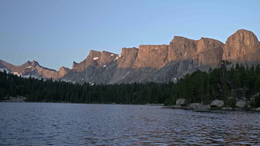 Low static twilight view of Valentine Lake in the Wind River Range, Wyoming, with serene water and distant mountain scenery