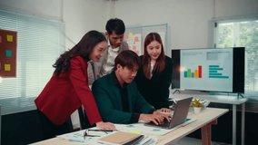 Celebrating business success, a team of professionals cheers and exchanges high fives around a laptop. Joyful expressions and teamwork highlight their achievement in the office - Powered by Shutterstock - Get 15% off with code: PIKWIZARD15