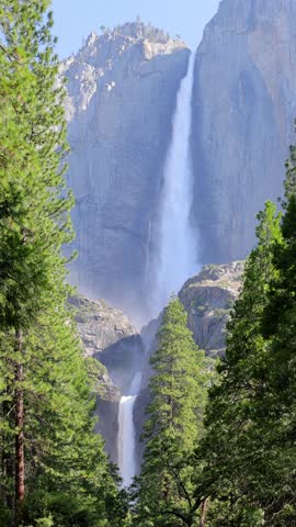 Yosemite Falls seen through the trees at Yosemite National Park in California.