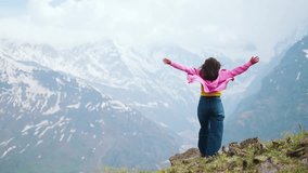 4K shot of Indian Girl raising her hands up with emotions of joy and sense of satisfaction. Girl on top of the mountain celebrating summit. The concept of achieving success. Happy and drunk on life - Powered by Shutterstock - Get 15% off with code: PIKWIZARD15