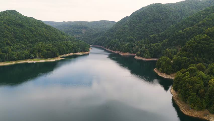 Vidraru dam and lake aerial scene, Arges, Romania. Top cinematic aerial view. Romanian wild nature and landscape from above