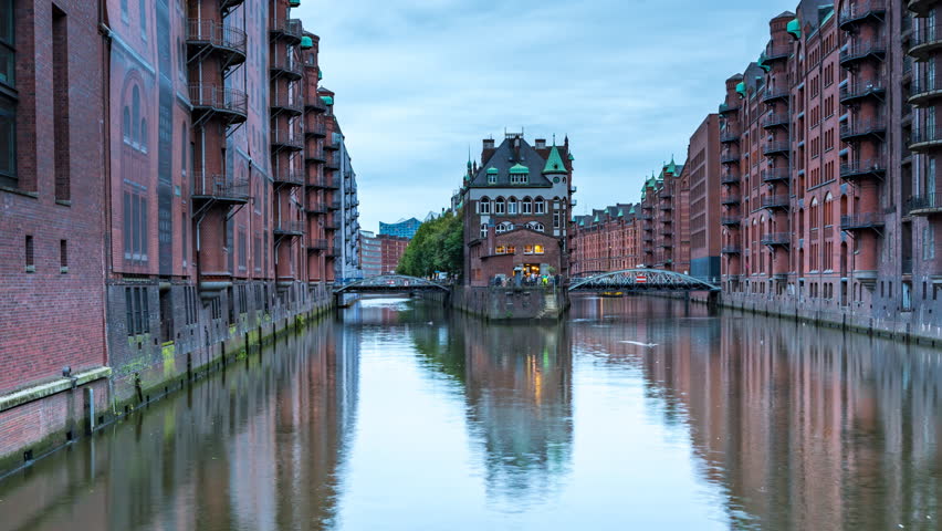 Hamburg, Germany. Night view of Speicherstadt in Hamburg, Germany. Time-lapse with illuminated historical buildings at sunset with reflection in the water 4K time lapse.