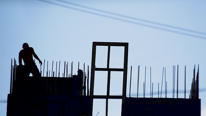 Outlines of builders on a city construction site