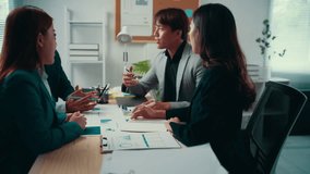 Business team engaging in discussion, sharing ideas and analyzing reports around a conference table in a bright office setting - Powered by Shutterstock - Get 15% off with code: PIKWIZARD15