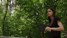 Ping pong player, competing in a table tennis tournament, focused on a match outside in the park. - Powered by Shutterstock - Get 15% off with code: PIKWIZARD15