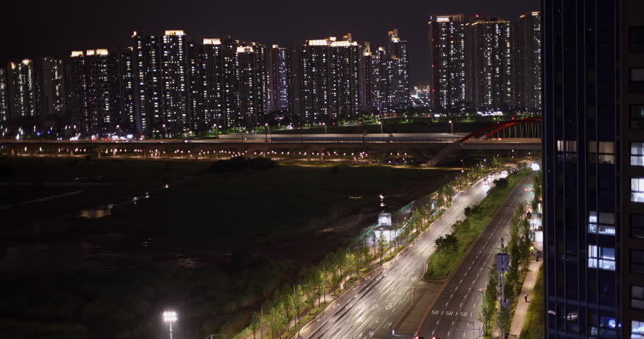 City with skyscrapers at night on a rainy day. Incheon Seoul South Korea. Timelapse video.