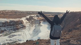 Freedom tourist woman enjoying on viewpoint of Gullfoss waterfall or Golden Falls with extreme hvita river flowing in canyon on winter at Iceland - Powered by Shutterstock - Get 15% off with code: PIKWIZARD15