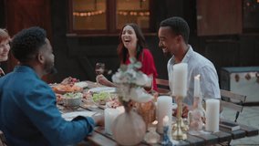 Group of friends sharing a meal and wine at a beautifully set outdoor table, enjoying a relaxed evening together. Friends Enjoying a Candlelit Outdoor Dinner with Wine - Powered by Shutterstock - Get 15% off with code: PIKWIZARD15