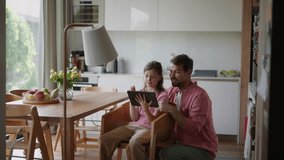 Father explaining daughter how to work with smart home automation system, adjusting lighting and air conditioning. Smart home technology for sustainable living. - Powered by Shutterstock - Get 15% off with code: PIKWIZARD15