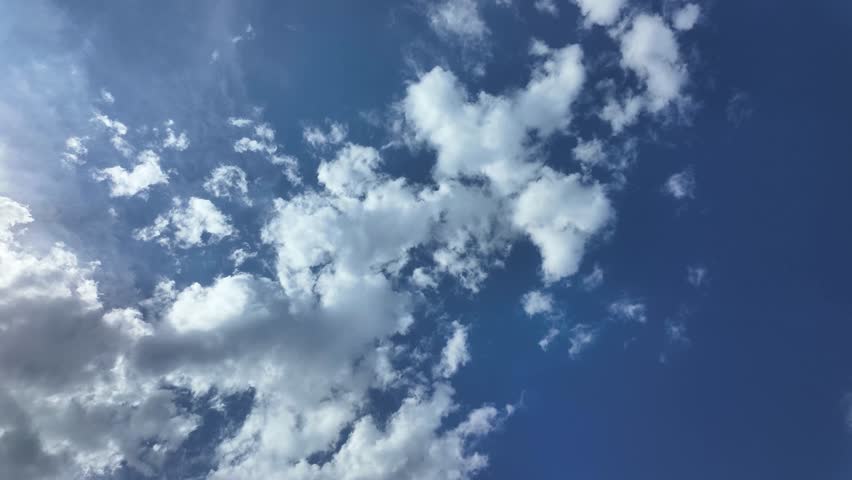 Moving clouds in the blue sky. Timelapse