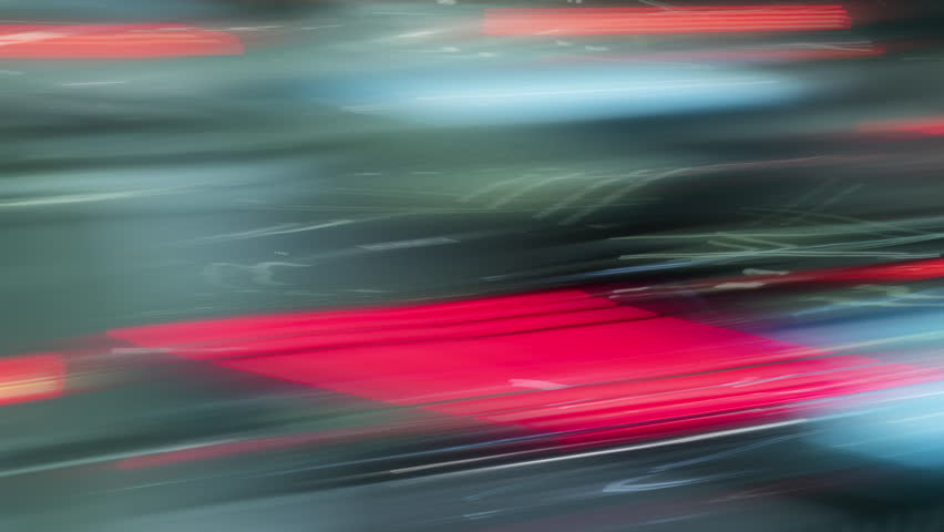 Long exposure time-lapse rush hour drive in big city at night, bright colorful light trails from vehicles, lot of driving cars speedy traffic lights blurred fast motion, abstract timelapse city life