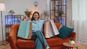 Satisfied Caucasian young woman happy shopaholic consumer came back home after shopping holiday sale in mall with many paper bags. Girl satisfied received parcels from online order at modern apartment - Powered by Shutterstock - Get 15% off with code: PIKWIZARD15