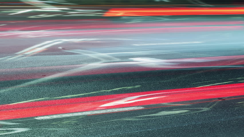 Long exposure time-lapse rush hour drive in big city at night, bright colorful light trails from vehicles, lot of driving cars speedy traffic lights blurred fast motion, abstract timelapse city life