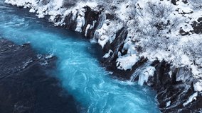 River in Iceland, Snowy Hills and Waterfalls in Winter, Magical Blue Glacial Water with a Huge Current. Hraunfossar - Powered by Shutterstock - Get 15% off with code: PIKWIZARD15