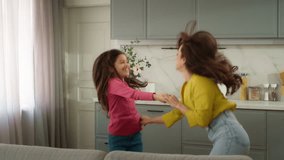 Joyful happy laughing Caucasian family woman female mother dancer holding hands little girl child kid daughter dancing music celebrating moving day relocation dance together holidays indoor apartment - Powered by Shutterstock - Get 15% off with code: PIKWIZARD15