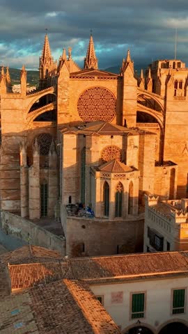 vertical video of sunrise aerial view of cathedral of Palma de Mallorca, Palma de Mallorca cityscape. Cathedral of Santa Maria, Royal Palace of La Almudaina. Balearic Islands. Spain. 