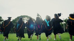 A group of women in graduation gowns are running across a field. Scene is celebratory and joyful, as the women are likely graduates who have just completed their studies - Powered by Shutterstock - Get 15% off with code: PIKWIZARD15