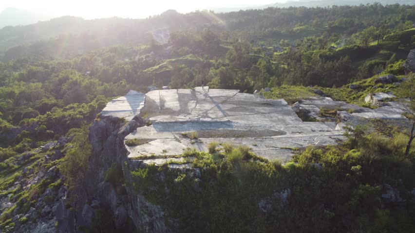 Explore the majestic marble quarry in East Nusa Tenggara. Witness the cutting-edge industry of Fatumnasi marble mine, where shiny, gray marble blocks are expertly extracted from Timor's hills and natu