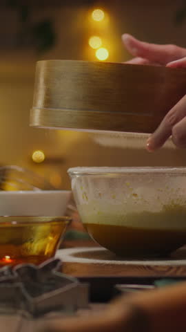 Vertical position. Sweets. Experienced housewife with kitchen utensils preparing homemade cookies for Christmas, at the kitchen table. Attentive housewife preparing baked goods at home