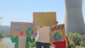 Children and adults protesting in front of a polluting energy plant, fighting against pollution, climate change, and waste. - Powered by Shutterstock - Get 15% off with code: PIKWIZARD15