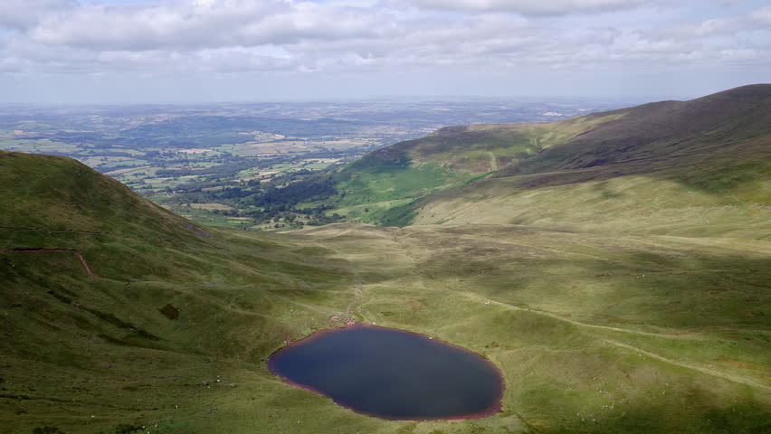 Handheld shot of a small lake in the Brecon Beacons, Wales (Cwm Llwch)