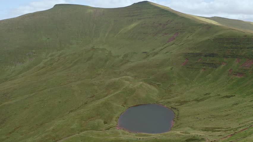 Aerial view of a small lake beneath Pen-y-Fan and Corn Du in the Brecon Beacons, Wales